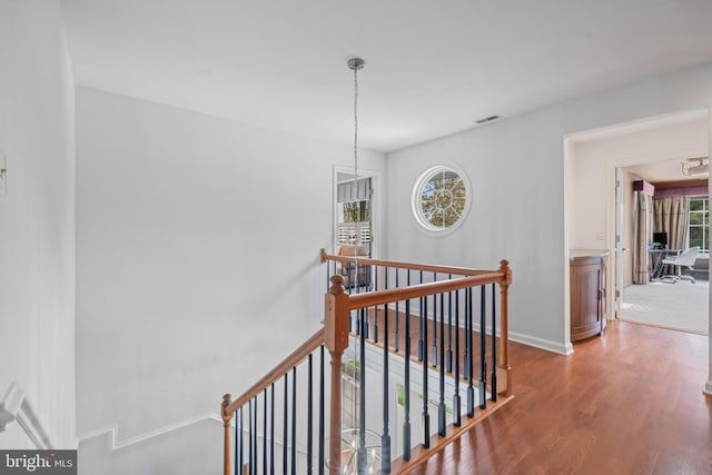 129 Kirwans Landing Ln, Chester, MD 21619 - hallway featuring an upstairs landing, wood finished floors, baseboards, and a chandelier