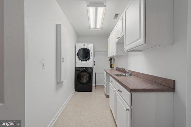 129 Kirwans Landing Ln, Chester, MD 21619 - laundry area featuring stacked washer / dryer, baseboards, and cabinet space