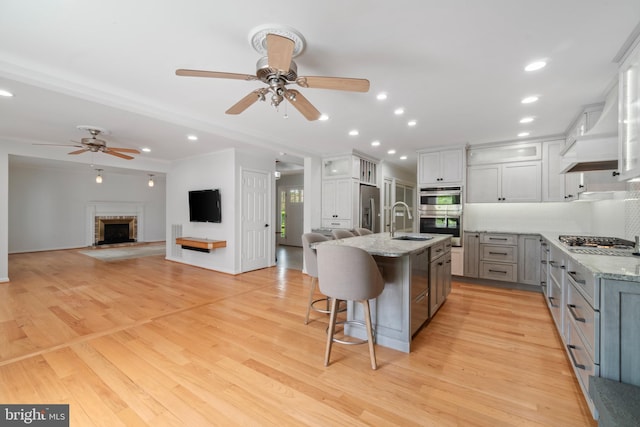 129 Kirwans Landing Ln, Chester, MD 21619 - kitchen with ceiling fan, stainless steel appliances, a sink, a breakfast bar, and recessed lighting