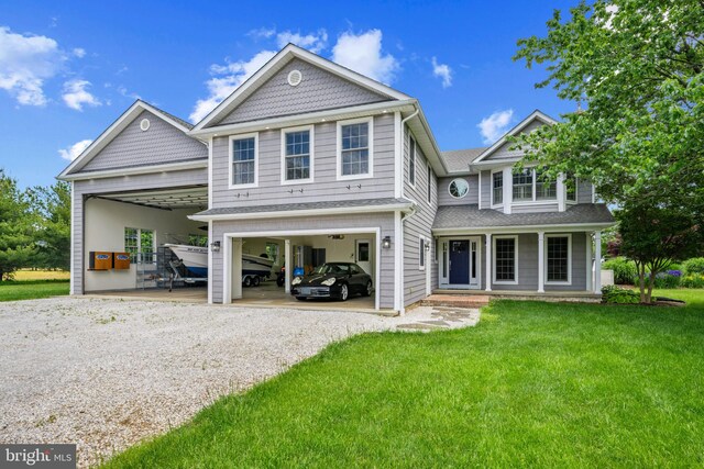129 Kirwans Landing Ln, Chester, MD 21619 - rear view of house featuring a garage, driveway, a lawn, a porch, and roof with shingles