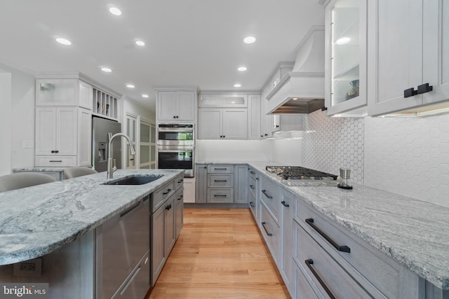 129 Kirwans Landing Ln, Chester, MD 21619 - kitchen with a sink, appliances with stainless steel finishes, premium range hood, tasteful backsplash, and recessed lighting