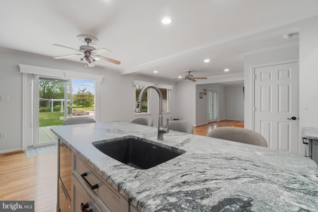 129 Kirwans Landing Ln, Chester, MD 21619 - kitchen featuring a sink, a ceiling fan, light stone countertops, recessed lighting, and light wood-style floors