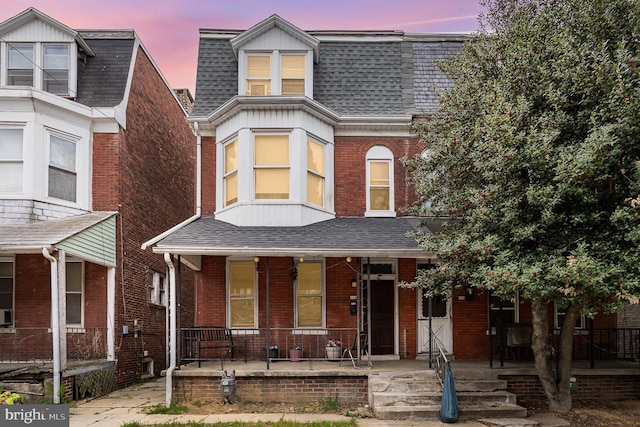 804 W King St, York, PA 17403 - view of front of house featuring roof with shingles, covered porch, mansard roof, and brick siding