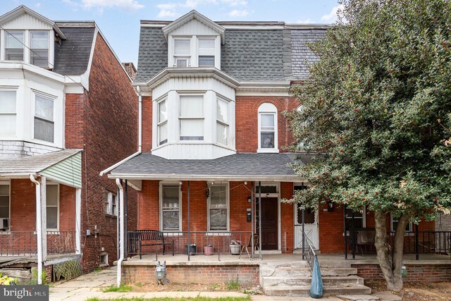 804 W King St, York, PA 17403 - view of front of home featuring brick siding, roof with shingles, mansard roof, and covered porch