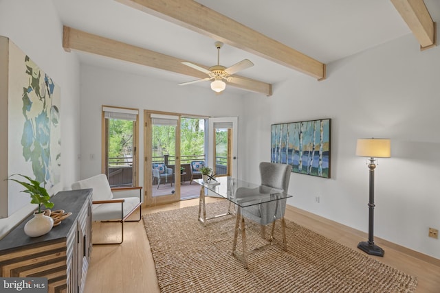 office with beam ceiling, baseboards, a ceiling fan, and light wood-style flooring