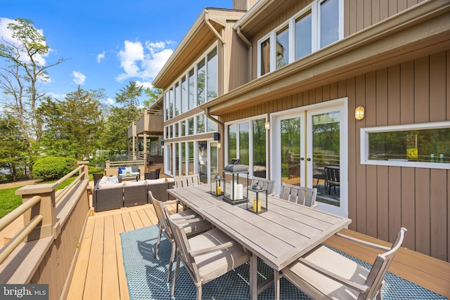 wooden deck featuring an outdoor living space, outdoor dining space, and french doors