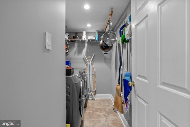 clothes washing area with washer and dryer, laundry area, baseboards, and recessed lighting