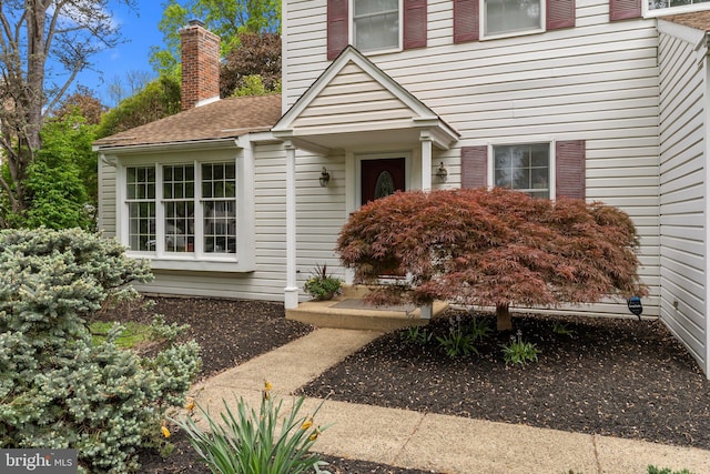 entrance to property featuring a chimney