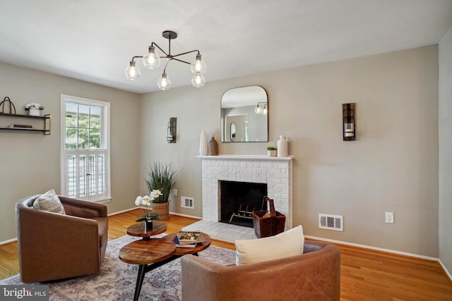 living area featuring baseboards, visible vents, and wood finished floors