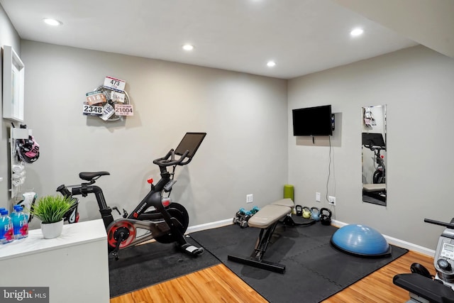 exercise area with recessed lighting, baseboards, and wood finished floors