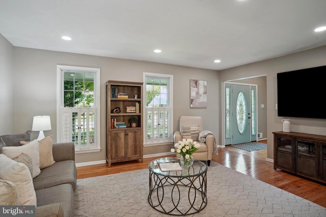 living room with recessed lighting, wood finished floors, and a healthy amount of sunlight