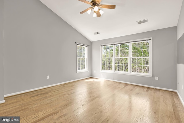 spare room with visible vents, light wood finished floors, baseboards, and ceiling fan