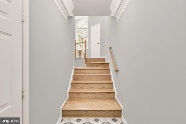 staircase featuring baseboards