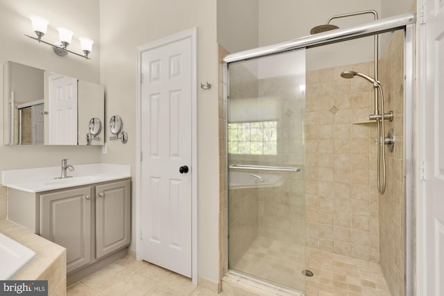 bathroom with vanity, tile patterned flooring, and a shower stall