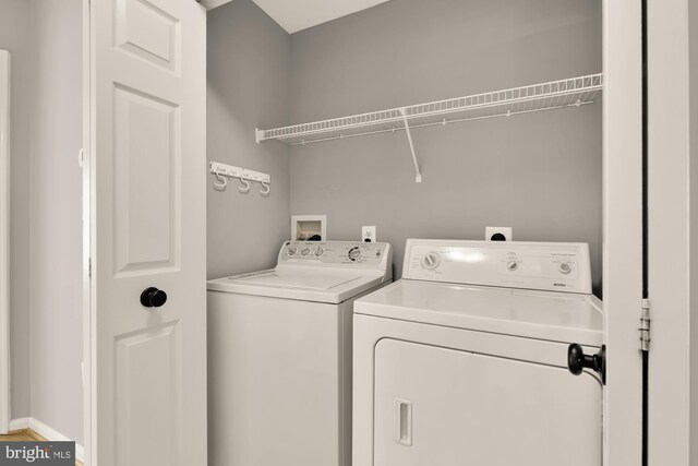 clothes washing area with washing machine and clothes dryer and laundry area