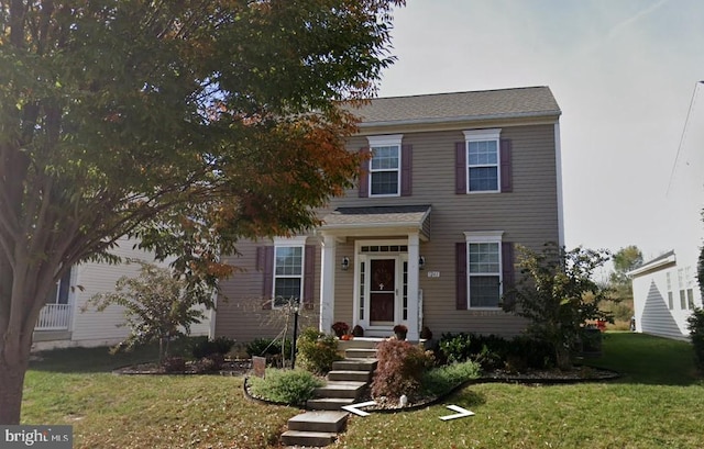 colonial home featuring a front yard
