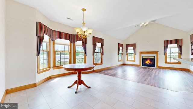 28342 Discount Land Rd, Laurel, DE 19956 - interior space featuring a glass covered fireplace, visible vents, baseboards, lofted ceiling, and ceiling fan with notable chandelier
