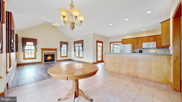 28342 Discount Land Rd, Laurel, DE 19956 - kitchen featuring a chandelier, a glass covered fireplace, open floor plan, white appliances, and a peninsula