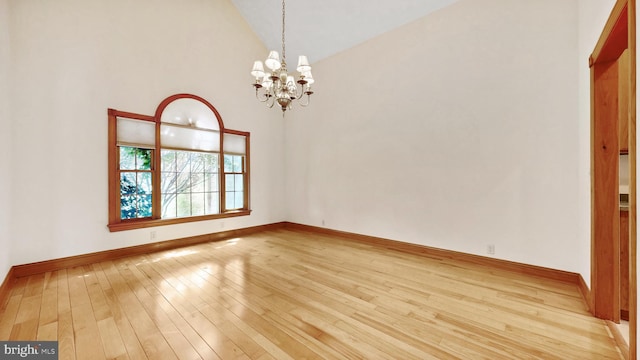 28342 Discount Land Rd, Laurel, DE 19956 - spare room featuring baseboards, high vaulted ceiling, an inviting chandelier, and light wood finished floors