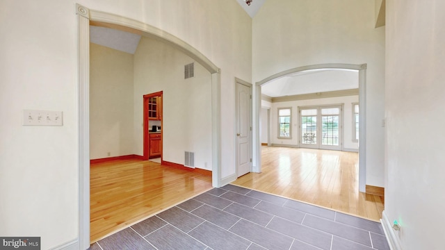 28342 Discount Land Rd, Laurel, DE 19956 - entrance foyer featuring a towering ceiling, arched walkways, visible vents, and dark wood-style flooring