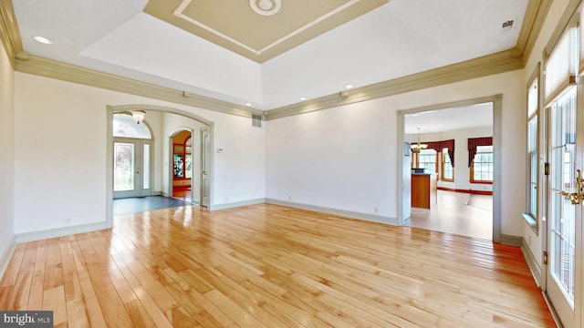 28342 Discount Land Rd, Laurel, DE 19956 - unfurnished room with arched walkways, ornamental molding, light wood-type flooring, visible vents, and a notable chandelier