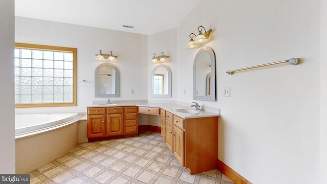 28342 Discount Land Rd, Laurel, DE 19956 - bathroom with visible vents, a bath, double vanity, and a sink