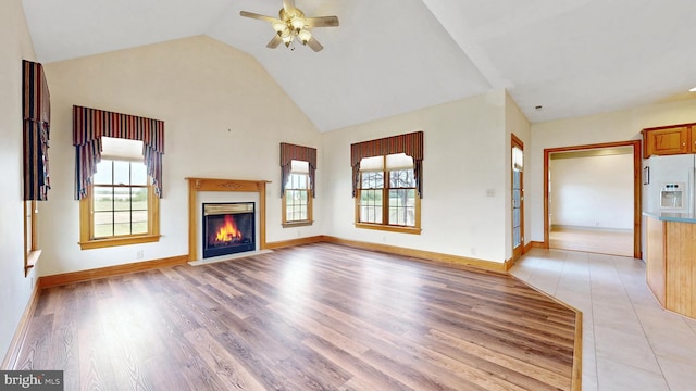 28342 Discount Land Rd, Laurel, DE 19956 - unfurnished living room featuring a ceiling fan, baseboards, light wood-style floors, and a glass covered fireplace