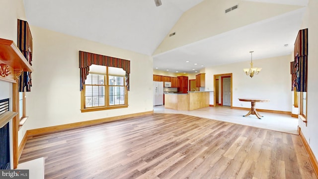 28342 Discount Land Rd, Laurel, DE 19956 - unfurnished living room with a fireplace, light wood finished floors, an inviting chandelier, and visible vents