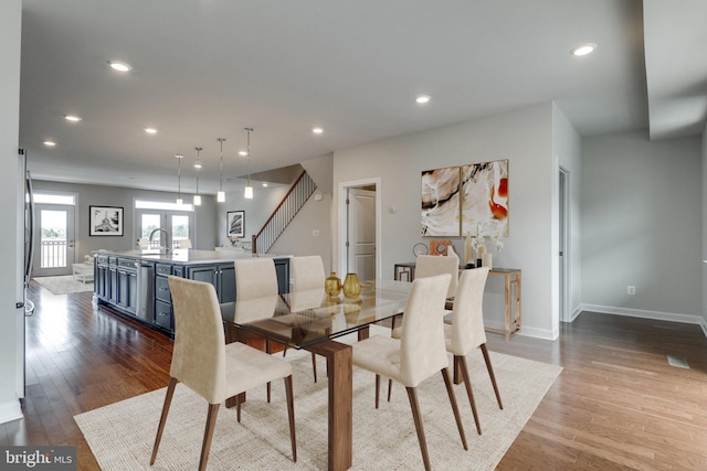 dining area with baseboards, stairs, recessed lighting, and dark wood-type flooring