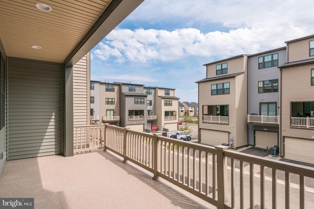 balcony featuring central air condition unit and a residential view