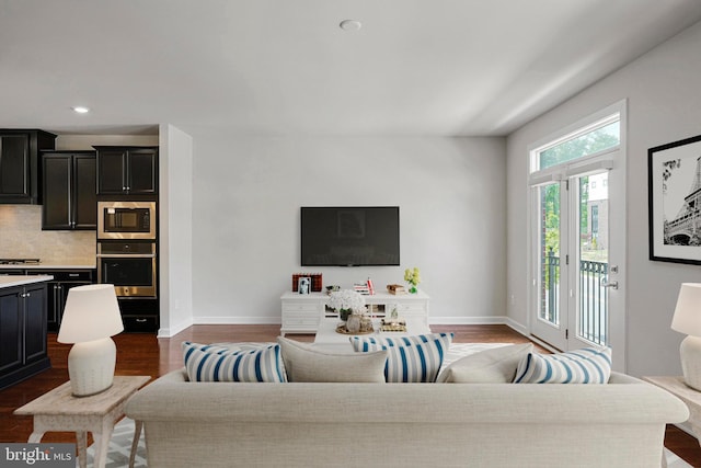 living room with baseboards, dark wood finished floors, and recessed lighting