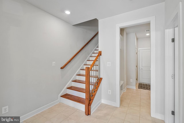 staircase featuring recessed lighting, baseboards, and tile patterned floors