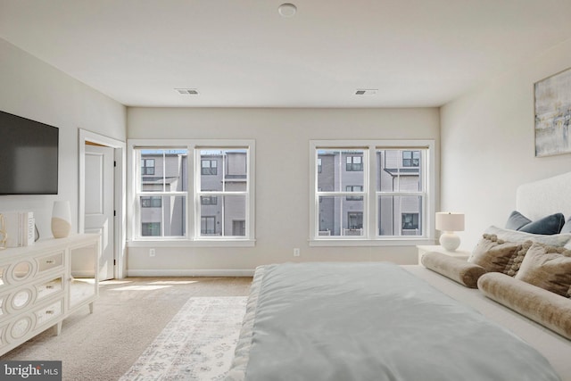 bedroom featuring baseboards, visible vents, and carpet floors