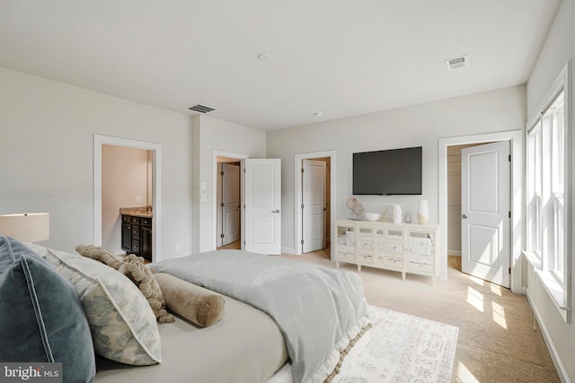 bedroom featuring light colored carpet, multiple windows, and visible vents