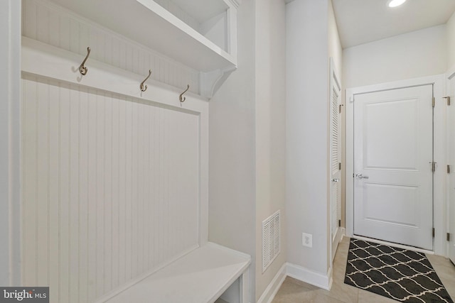 mudroom with baseboards, light tile patterned floors, and visible vents