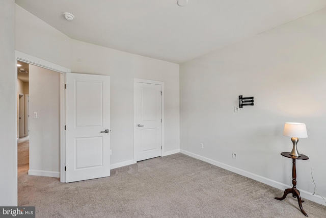unfurnished bedroom featuring baseboards and carpet