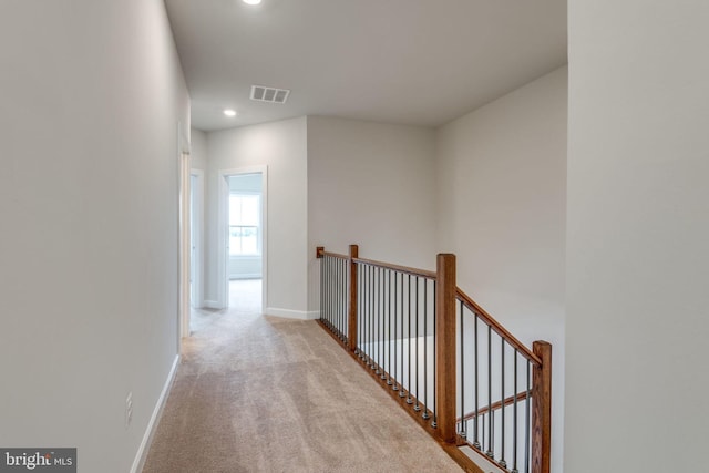 hall with an upstairs landing, visible vents, recessed lighting, carpet floors, and baseboards
