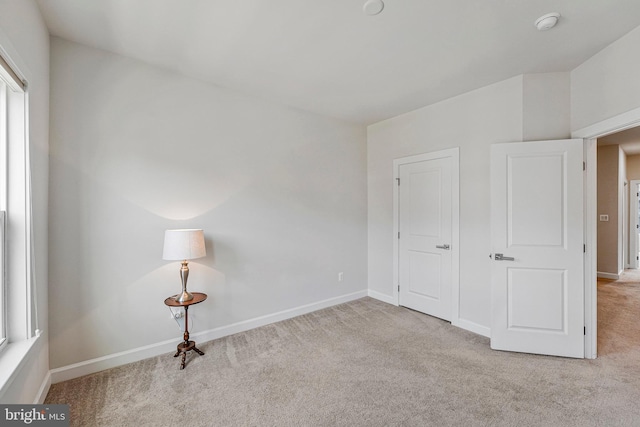 unfurnished bedroom featuring baseboards and carpet