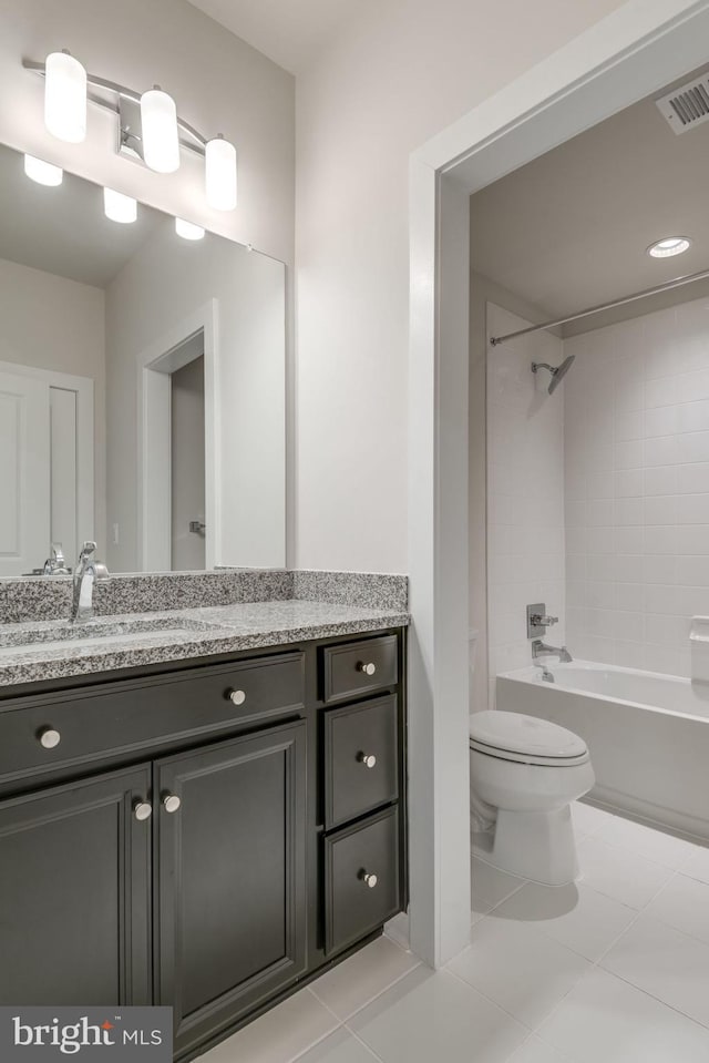 bathroom with toilet, vanity, visible vents, tile patterned flooring, and bathtub / shower combination