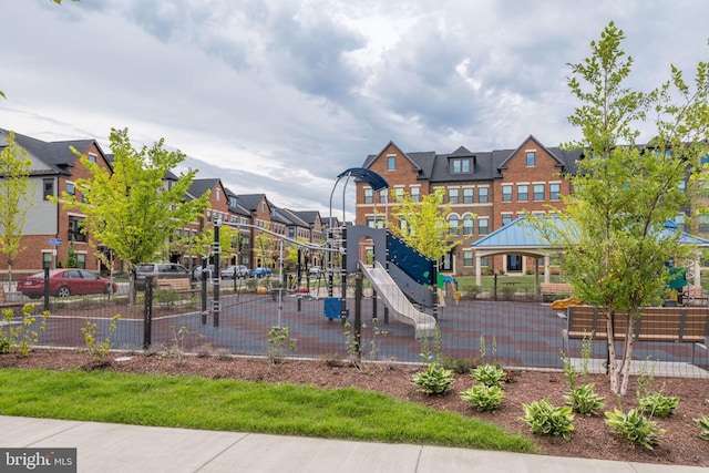 view of jungle gym featuring a residential view and fence