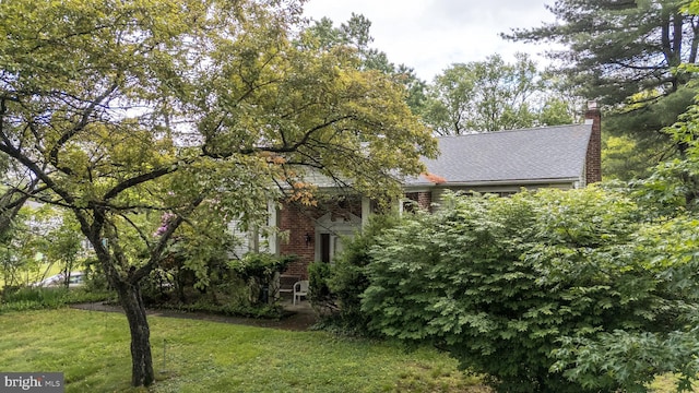 43 Harriet Rd, Southampton, PA 18966 - view of front of house with a front lawn, a chimney, and brick siding