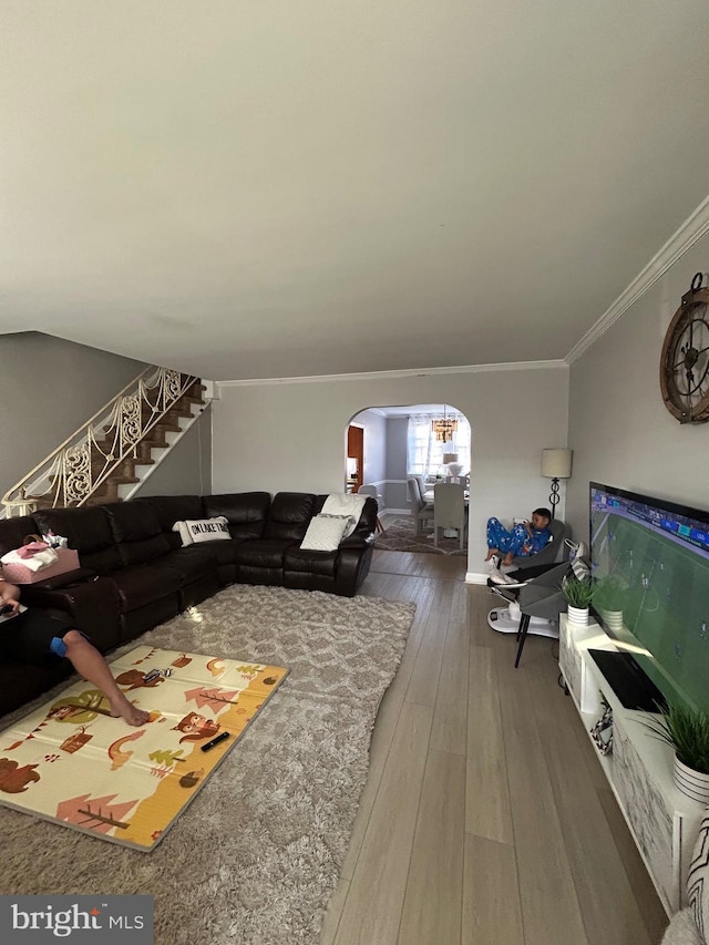 3015 Rawle St, Philadelphia, PA 19149 - living room featuring arched walkways, baseboards, stairway, crown molding, and hardwood / wood-style floors