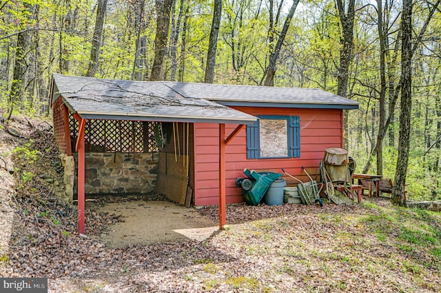 view of outdoor structure with a wooded view