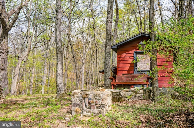 view of outbuilding with a wooded view