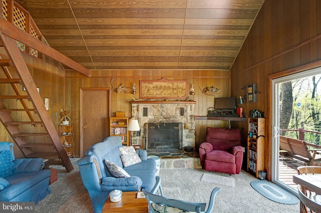 living room featuring wood walls, wood ceiling, and lofted ceiling