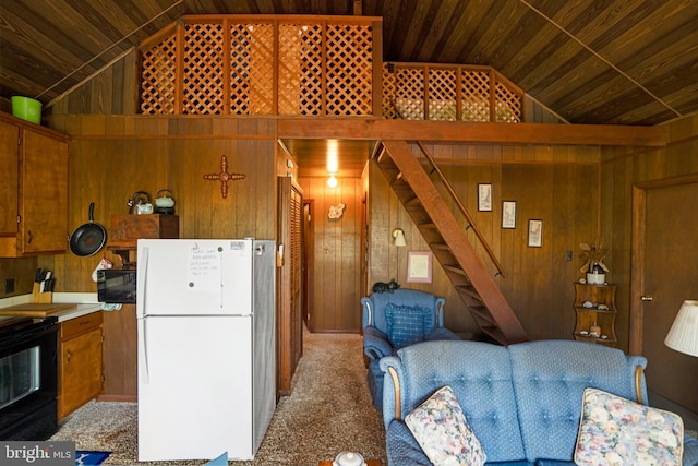 kitchen with freestanding refrigerator, wood ceiling, lofted ceiling, and wood walls