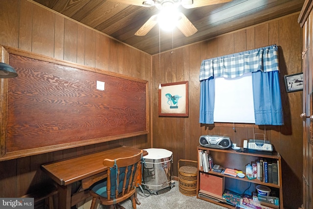 misc room featuring carpet floors, wood walls, wood ceiling, and ceiling fan