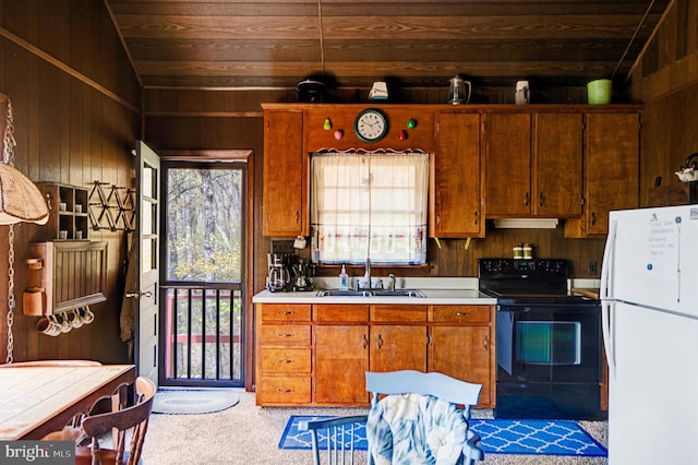 kitchen with wood ceiling, black electric range, a sink, freestanding refrigerator, and carpet