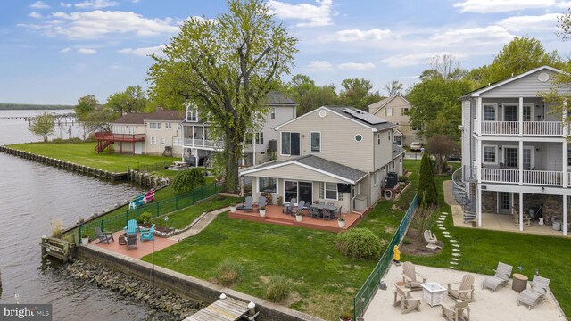 8354 Bletzer Rd, Baltimore, MD 21222 - back of property featuring a patio, a residential view, a fenced backyard, and a deck with water view
