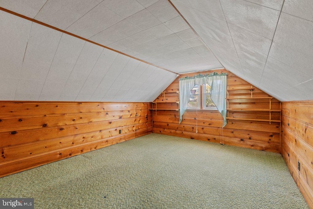 additional living space with wood walls, vaulted ceiling, and carpet flooring
